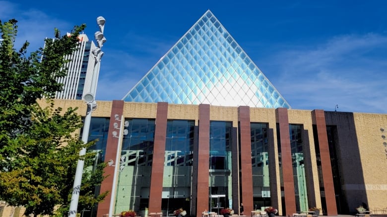 City hall windows reflect sunlight on a summer day. 