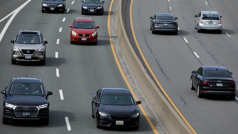 Cars drive on a highway.