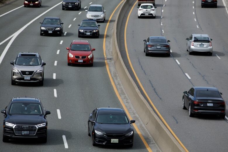 Cars drive on a highway.