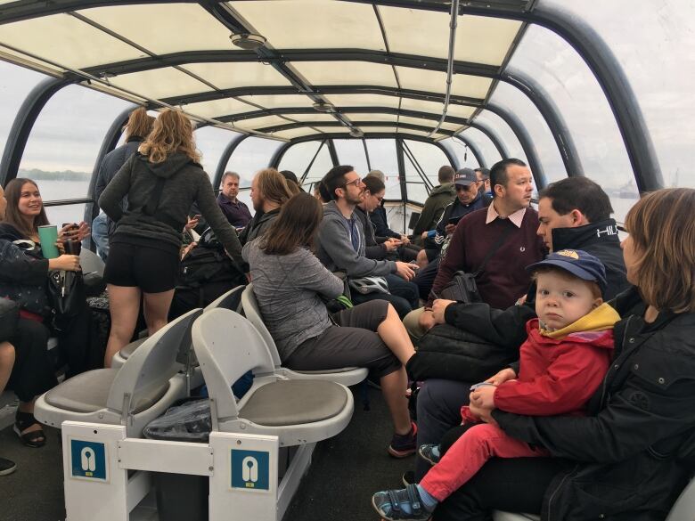 Passengers on a water shuttle traverse the St. Lawrence River. 