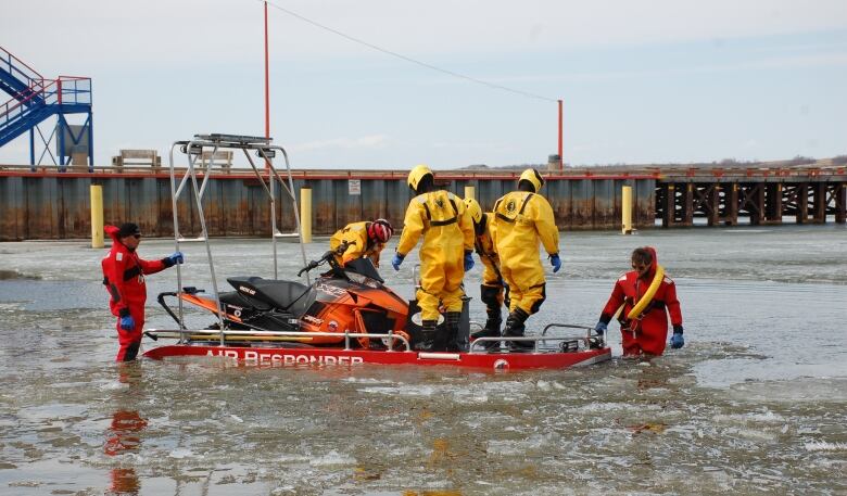 A team of water rescuers work on a boat.