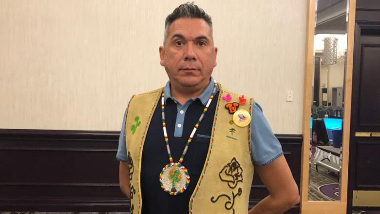 A man wearing Indigenous regalia.