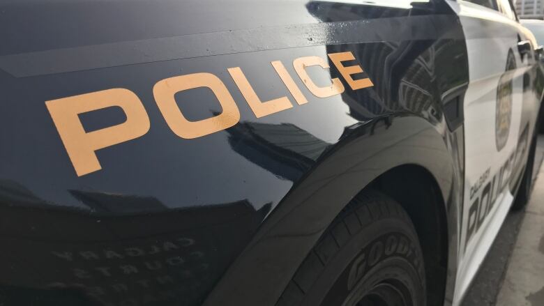 The back of a police car, with the words 'POLICE' clearly visible.