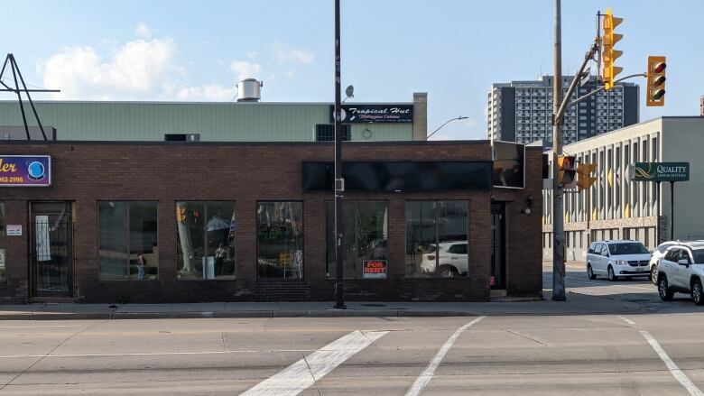 A street corner with a low brick building