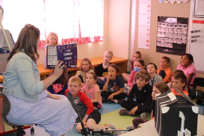 teacher at front of class of young students