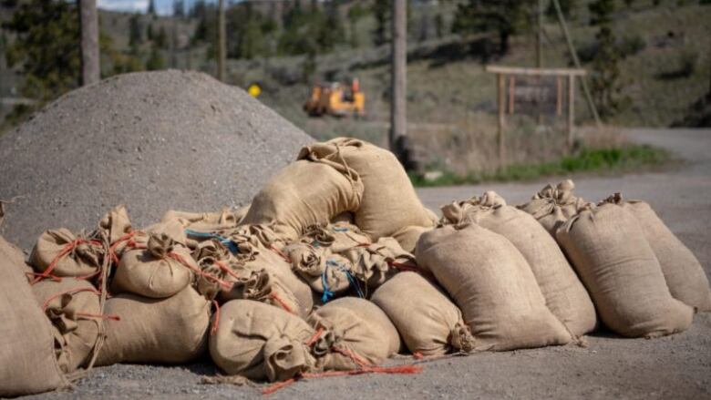 An image from the Thompson-Nicola Regional District shows sandbags piled on a gravel road in anticipation of flooding. June 7, 2022.