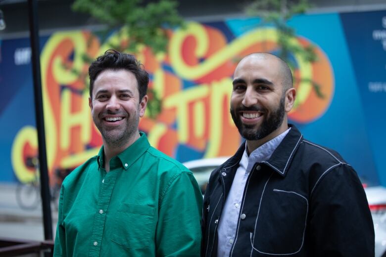 Elie Chivi and Andrew Murphy, curator of the Inside Out LGBT film festival in Toronto, pose in front of the TIFF Lightbox theatre where screenings took place. Photo taken June 9, 2022.