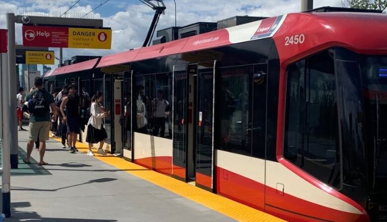 Passengers board the CTrain at the Calgary Zoo station. 