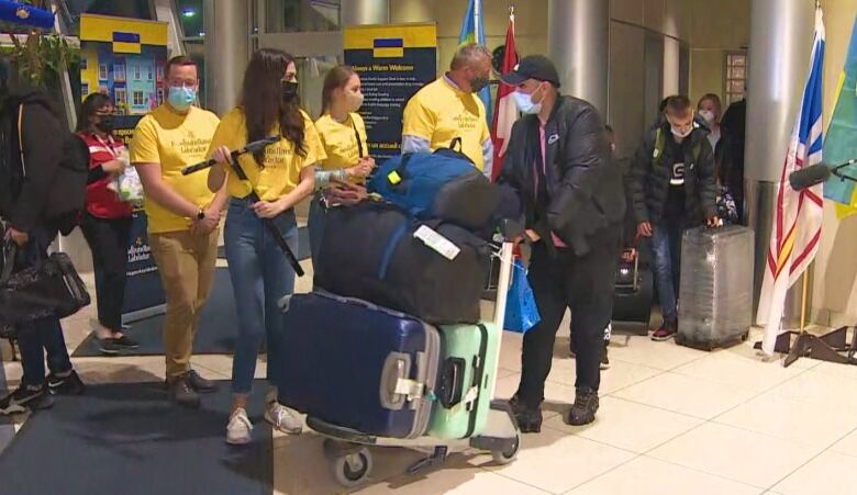 Ukrainian refugees arriving at St. John's International Airport Tuesday.