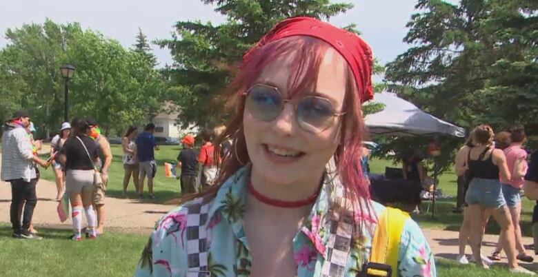 Saige Davidson, who wore a colourful outfit and had red hair on Saturday, smiles while talking about participating in a pride parade for the first time.