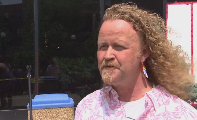 Brandon Pride chairperson Kenneth Jackson wears rainbow beaded earrings and a pink-and-white shirt at the parade on Saturday.