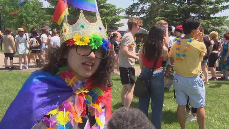 Cole Frison wears a crown and rainbow flowers at the Brandon Pride parade on Saturday.