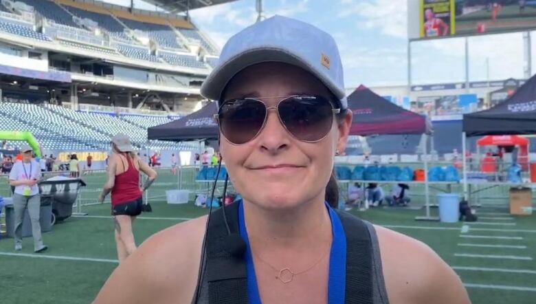 A woman in sunglasses poses for the camera