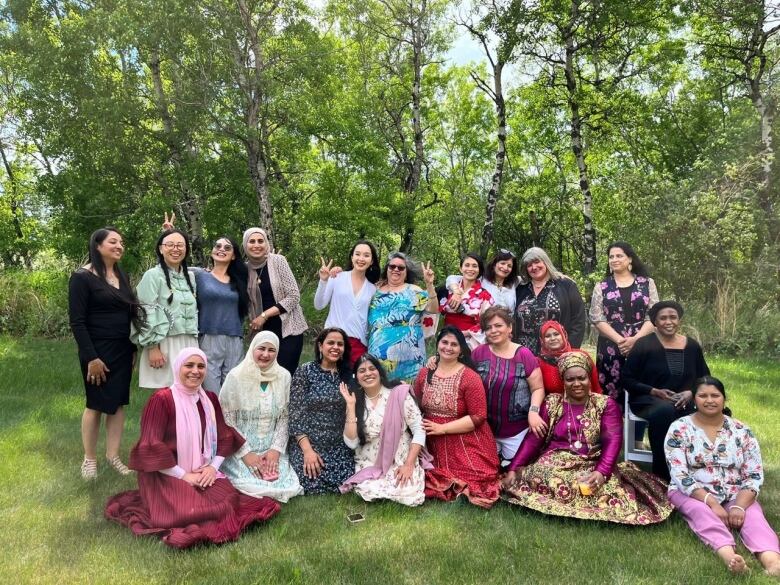 A large group of women smile for the camera. 