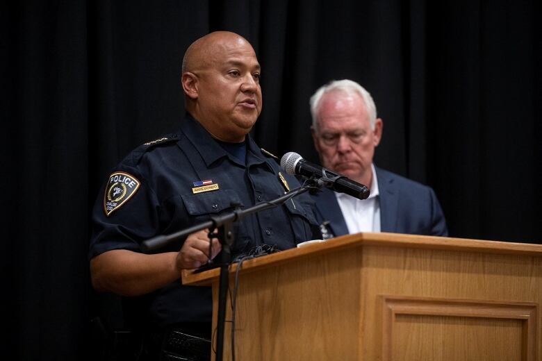 Uvalde schools police chief at a podium. 