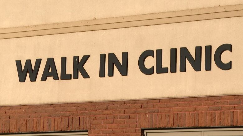 Sign on building says Walk In Clinic.