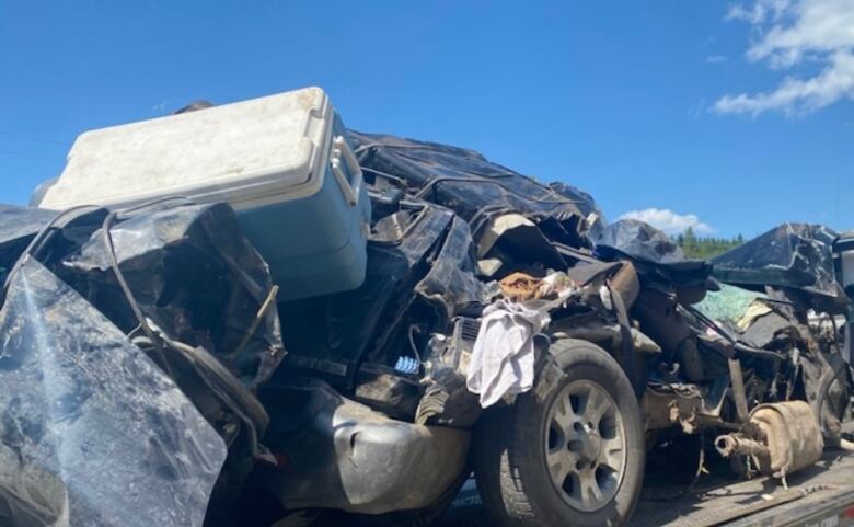 The crushed, metal remains of a vehicle that was destroyed in a serious car accident.