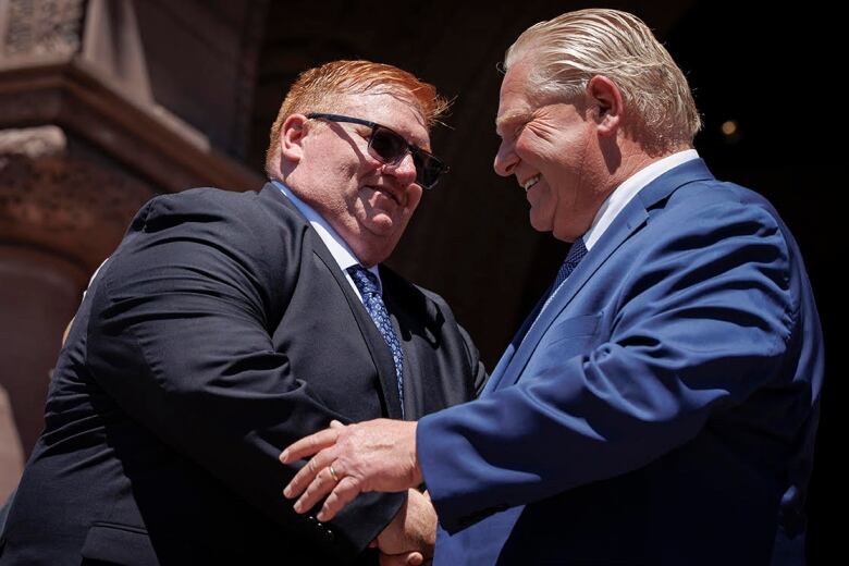 Graydon Smith shakes hands with Premier Doug Ford, 