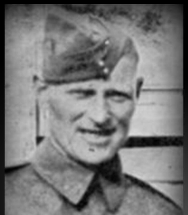 A black and white image of a man wearing a Canadian military uniform. 