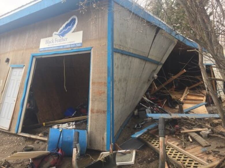 A badly damaged plywood warehouse.