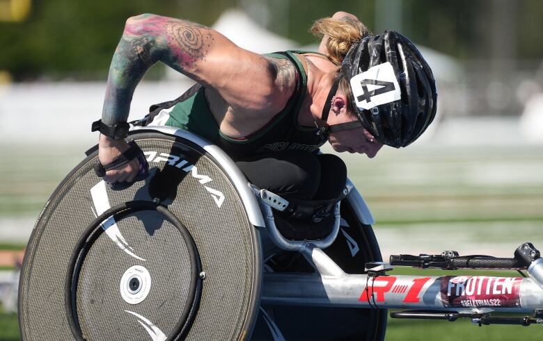 A female wheelchair racer on a track.