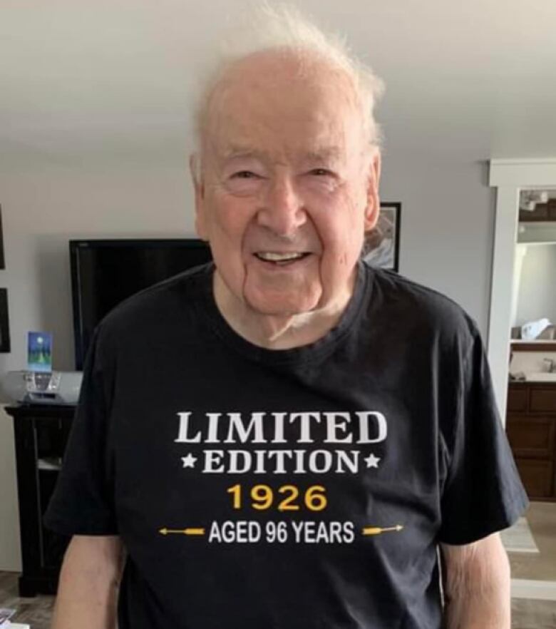 A smiling man wears a T-shirt that reads, Limited Edition 1926 | Aged 96 years 