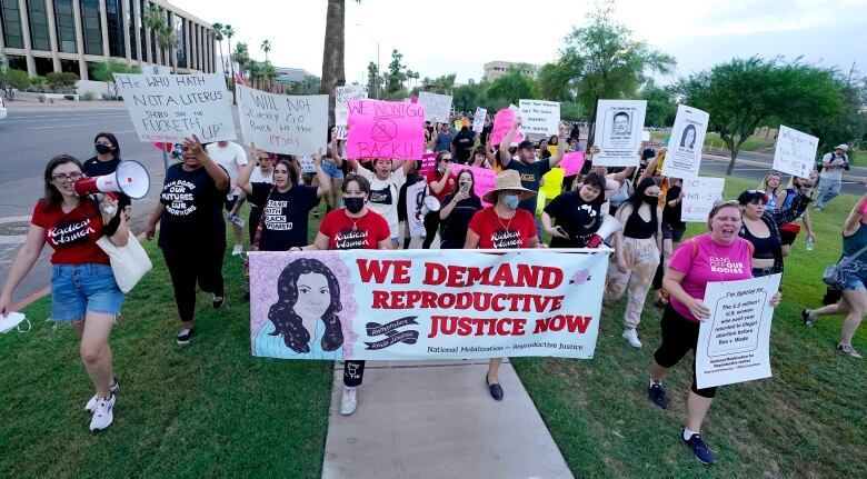 Protesters march around the Arizona Capitol after the Supreme Court's decision to overturn Roe v. Wade on Friday, June 24, 2022, in Phoenix. 