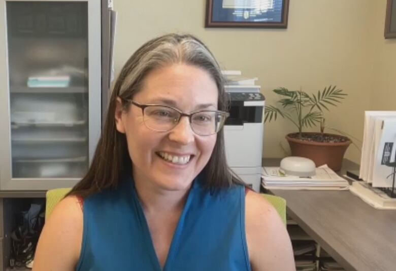 Smiling woman looking into camera.