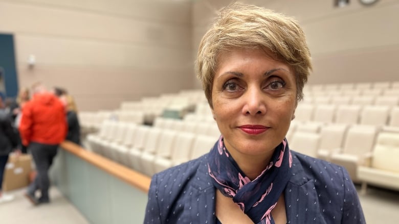 A close-up shot of a woman with short cropped hair.