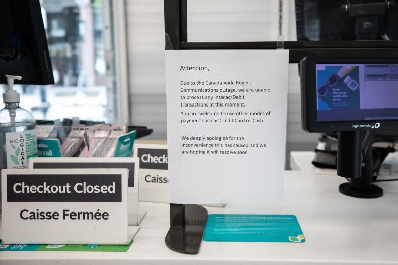 A printed sheet of paper stuck on a checkout counter. It reads: 