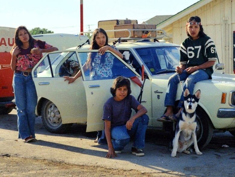 Indigenous Action Movement activist Kat Norris (left), of Lyackson First Nation, is seen behind a car with a moving trailer behind it, beside her siblings surround her on a move to Los Angeles in the late 1960s.