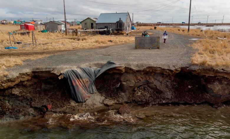 A washed out road is seen in an Arctic coastal village.