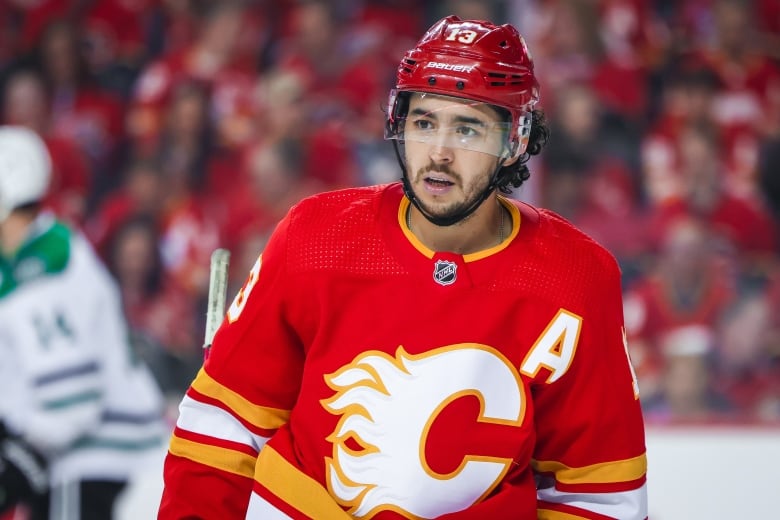 A man in a Calgary Flames hockey team uniform.