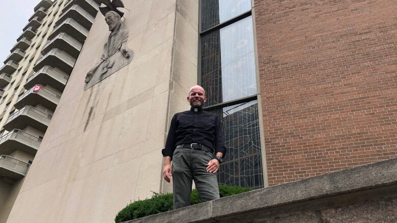 Pastor Mark Ehlebracht stands in front of St. Peter's Lutheran Church where 41 affordable housing units will be built.