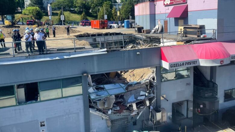 A collapsed parking deck and the damage to the office space below can be seen in an East Vancouver building on Thursday, July 14, 2022.