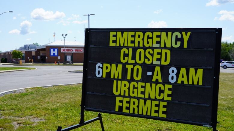 A sign tells people an emergency room at a hospital is closed between 6 p.m. and 8 a.m.