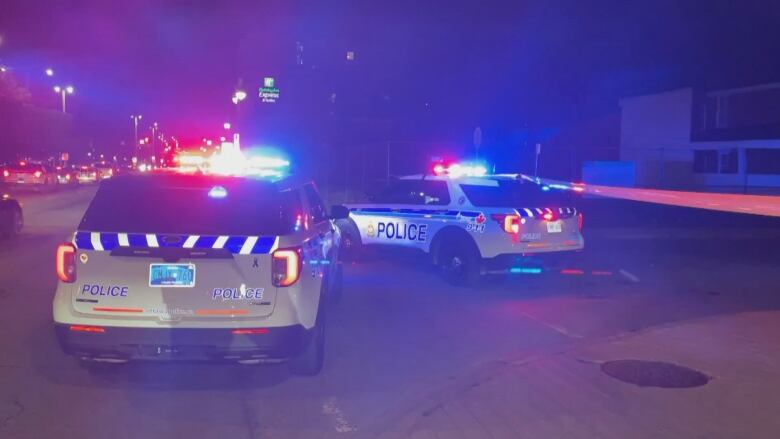 Police cruisers at night.