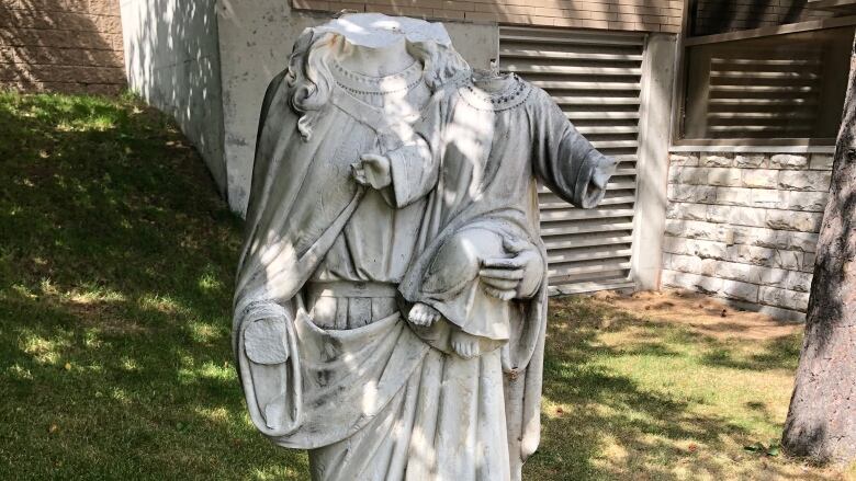 A headless statue stands in the courtyard outside of St. Anne-des-Pins church in Sudbury.