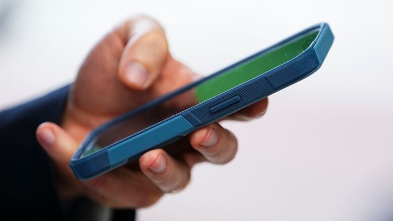 A close-up of someone typing on a cell phone. 