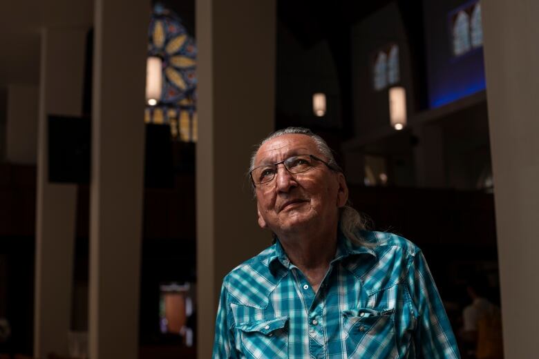 A man stands in a church.