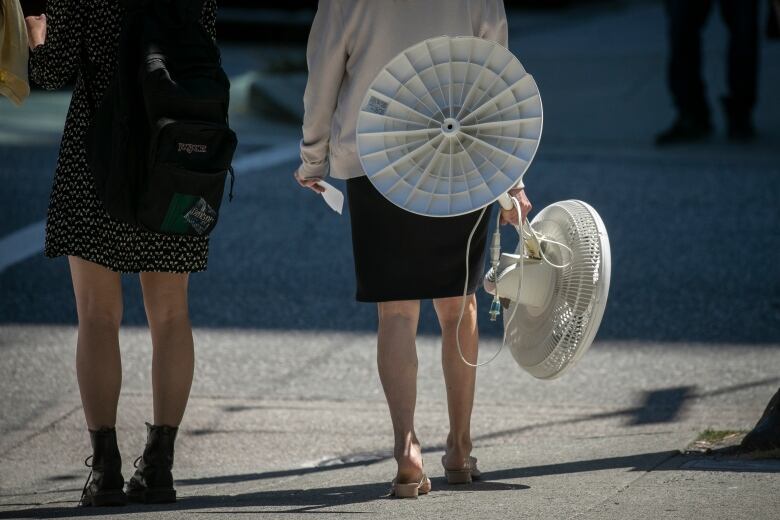 A person carries a fan