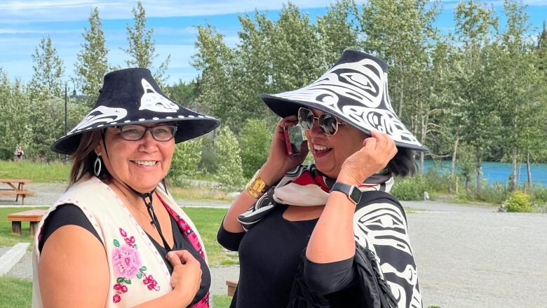 Dorothy Grant and Shirley Dawson posing with their traditional hats