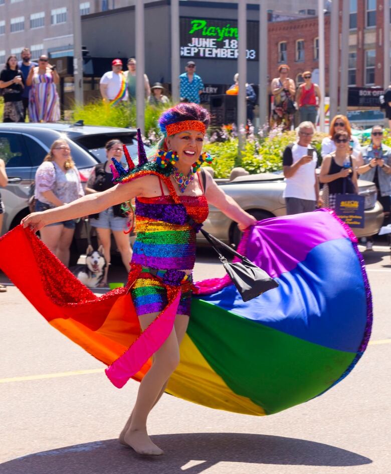 Woman swirling wearing a Pride rainbow skirt