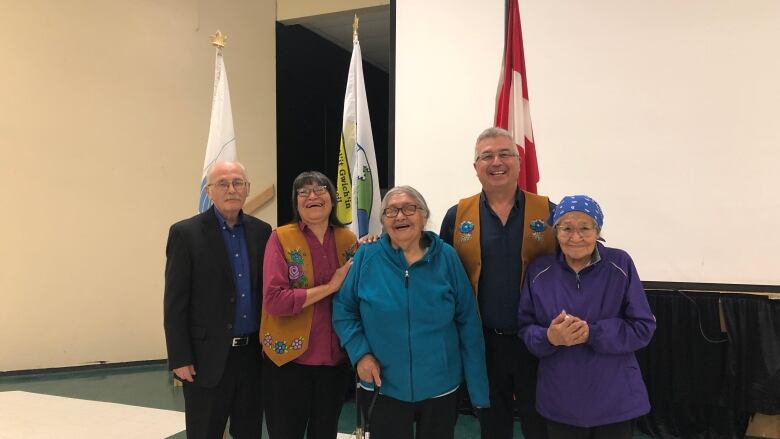 A portrait of five people smiling.