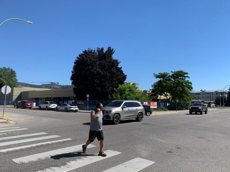 A man crosses a zebra crossing.