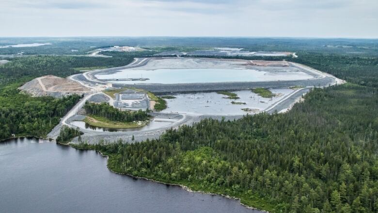 An aerial shot of the Touquoy gold mine in Moose River, N.S. including surrounding forest and the dame above Scraggy Lake.