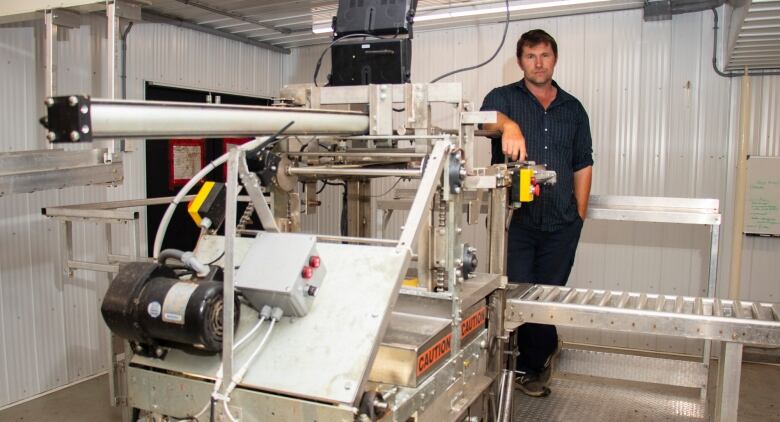 Machine in foreground, with person behind it.