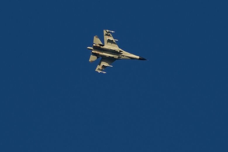 A fighter jet is seen against the sky.