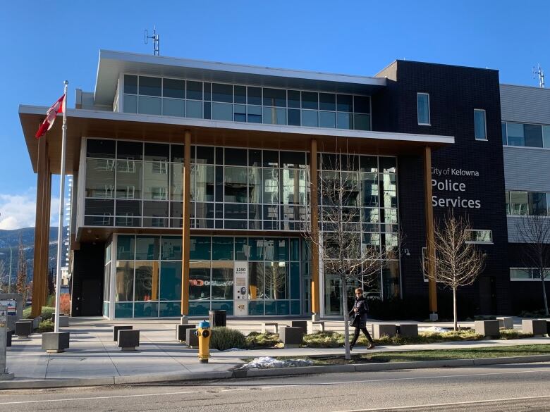 A large glass-fronted building with a sign on the right side that says City of Kelowna Police Services.