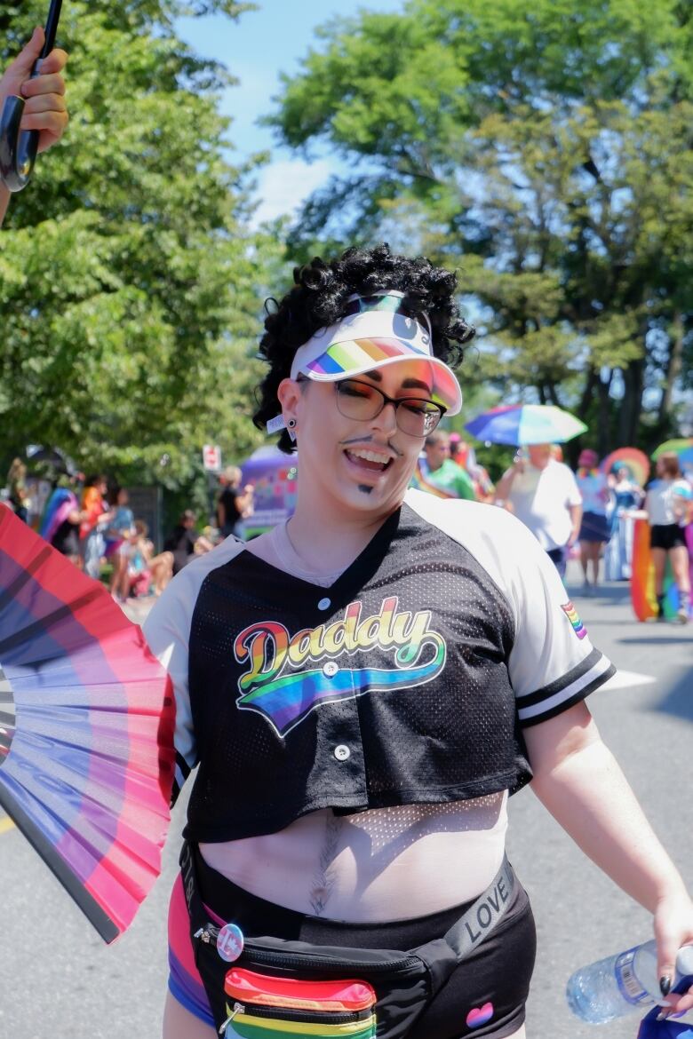 woman holding a fan and wearing a shirt that says 